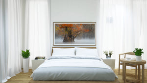 Modern bedroom with a bed, side tables, and artwork on the wall.