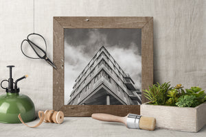 Monochrome photograph of a concrete building against a cloudy sky