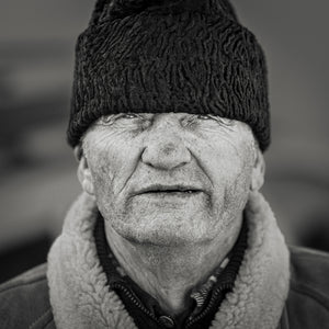 Close up black and white portrait of older man outdoors