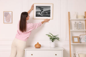 Mongolian eagle hunter holding bird of prey with wings spread wide