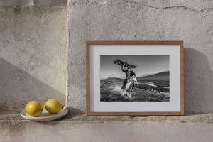 Black and white action portrait of eagle rider in Mongolian Altai