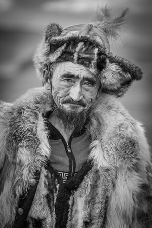 elderly Mongolian man wearing traditional fur hat portrait