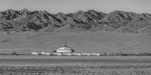 Rows of small yurts surround a large decorated central tent
