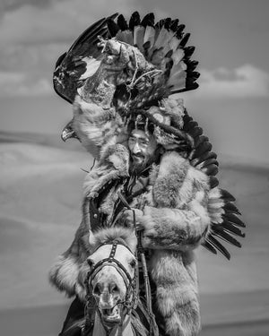 Golden eagle spreading its wings above a Mongolian rider