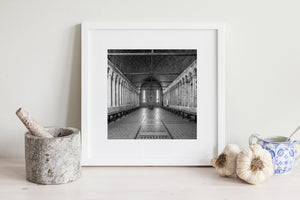 Monochrome architectural photograph of columns, arches and exposed roof beams