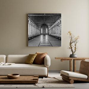Light from tall windows illuminates the tiled floor of the abbey refectory