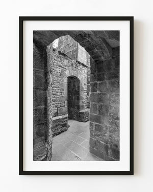Black and white stone passage with layered arches at Mont Saint-Michel