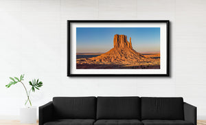 Warm orange rock contrasts with a cloudless blue sky