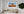 Panoramic desert photograph of a towering butte and distant mesas