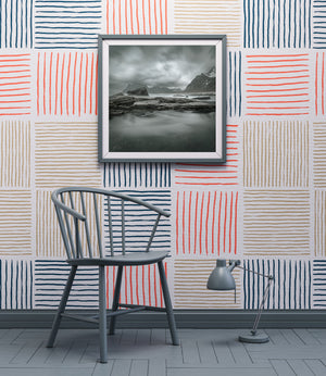 Norwegian seascape with dark rocks and snow-streaked mountains