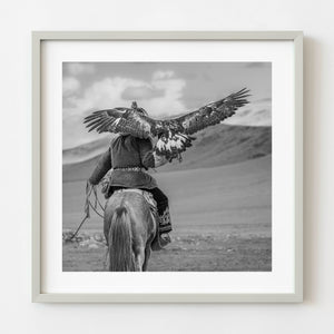 Kazakh eagle hunter riding horseback in western Mongolia
