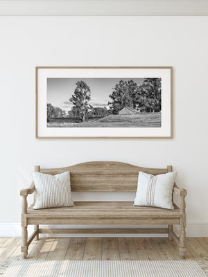 Monochrome photograph of vineyard rows and a rustic Napa Valley barn