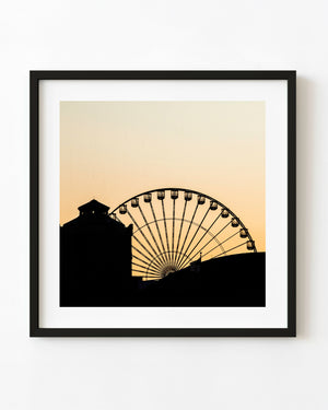 Navy Pier Ferris wheel silhouetted against a golden Chicago sunset