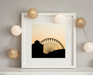 Ferris wheel cabins outlined above Chicago rooftops at sunset