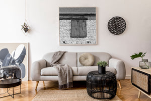 Sunlight on old wooden shutters and textured barn masonry