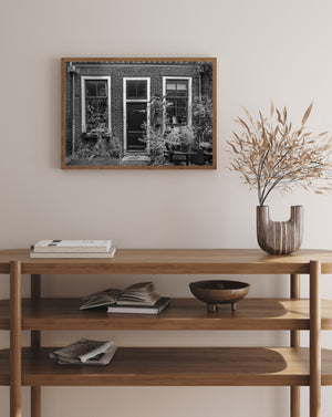 Black and white photograph of Dutch home with greenery