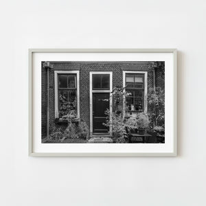 Amsterdam brick house with black and white window scene