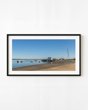 New Hampshire fishing harbour at low tide beneath a clear blue sky