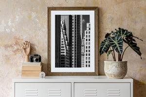 Black and white view of Manhattan architecture with bright facades between dark towers.