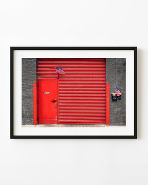 Red steel door and roller shutter with American flags in New York