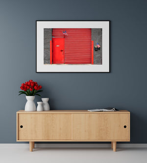 Weathered red doorway and brick wall in a New York street photograph