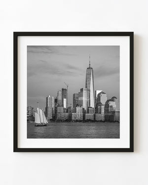 Sailboat beneath One World Trade Center and the New York skyline in black and white