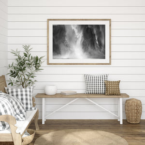Bright waterfall spray against textured dark rock