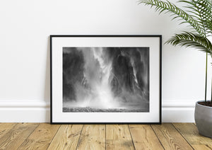 New Zealand cascade dissolving into white spray at the water’s edge