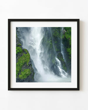 New Zealand fjord waterfall crashing over cliffs