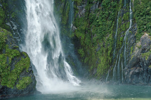 Abstract waterfall texture on dark stone cliff in Fiordland National Park