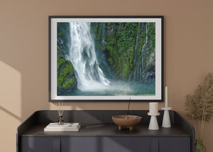 Moody waterfall scene photographed from boat in Milford Sound fjord