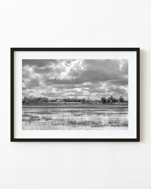 Northern Ontario barn across reflective water in black and white