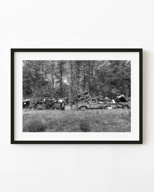 Black and white photograph of scrap cars in Northern Ontario