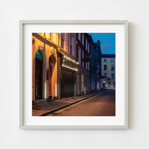Evening street with homes and shops in Derry Northern Ireland