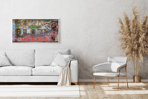 Old brick warehouse wall with balcony and dense graffiti street art