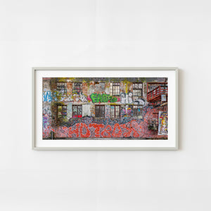 Colorful graffiti covering weathered brick wall with windows in Oslo