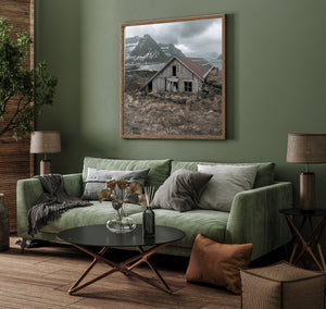 Grey clouds above a sheltered bay and old wooden boathouse