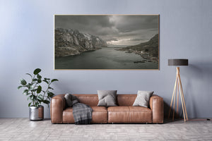 Dark fjord water leading toward a distant ocean horizon