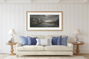 Cloudy light over rocky shores and sheltered fjord water
