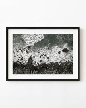 Aerial view of white surf breaking over a rocky Norwegian shore