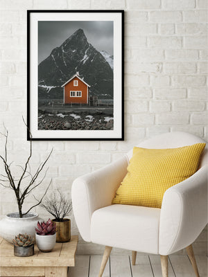 Olstinden rising behind a traditional waterfront rorbu