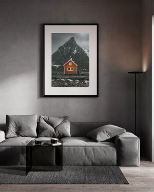 Warm orange timber contrasting with a rugged snow-streaked peak