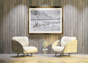 Norwegian mountains rising beyond a winter field and inlet