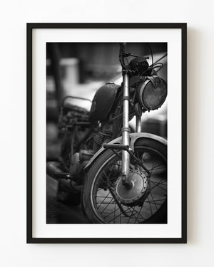 Old motorcycle parked on a Barcelona street in black and white