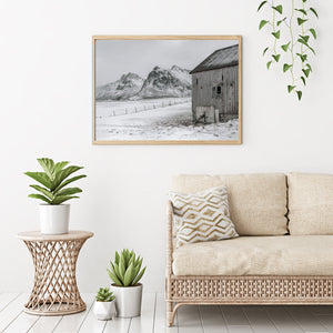 Broken fence leading to snowy beach in Norway