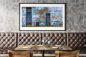 Detail of graffiti scribbles and peeling posters on wall