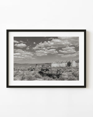 Old farm wagon and weathered barn in Currie, Nevada, in monochrome