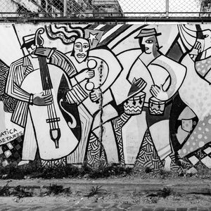 Painted bassist, percussionist and drummer on a weathered Havana wall