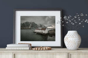 Old coastal hotel on timber supports beside rocky shores