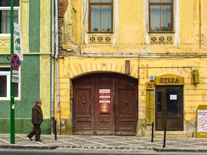 Crumbling yellow wall of Romanian pub in fall